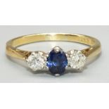 18ct yellow gold and platinum sapphire and diamond three stone ring, the central oval cut sapphire
