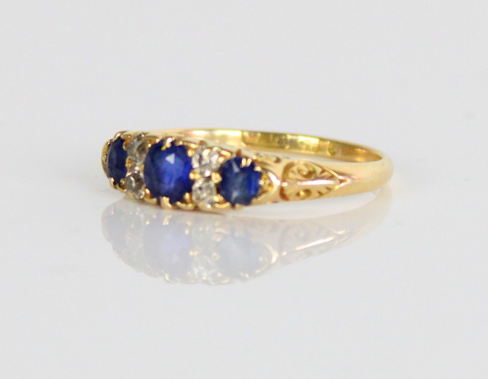 18ct yellow gold sapphire and diamond ring, the three graduated round cut sapphires separated by - Image 2 of 3