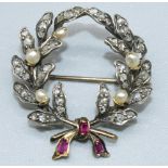 Yellow and white metal brooch in the form of a wreath set with diamonds and pearls, with ruby set