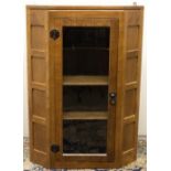 Robert "Mouseman" Thompson of Kilburn - an oak corner cabinet, glazed door enclosed by panelled