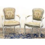 Pair of French Louis XV style fauteuil, painted carved and moulded frames with brass nailed woolwork