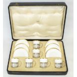 C20th century Shelley white bone china six place coffee service with gilt borders, the cans with