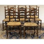 Set of eight C19th country made ash and elm rush seat ladderback dining chairs, with curved turned