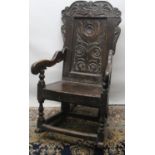 C17th oak wainscot chair, stylised flower carved back with scroll cresting, solid seat and shaped