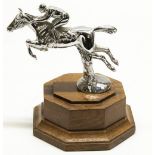 After Charles Paillet, a chromed metal car mascot, in the form of a race horse and jockey taking a