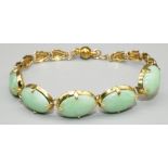 Yellow metal bracelet set with five cabochon jade plaques, with later magnetic clasp, no visible