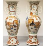 Pair of late C19th Japanese Kutani two handled vases, painted with figures in reserved panels of