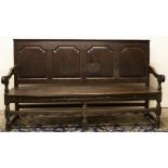 C18th and later oak settle, raised back with moulded top rail above four fielded panels, solid