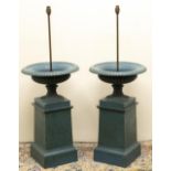Pair of cast iron campana shaped garden urns, lobed bodies on fluted supports and square bases,