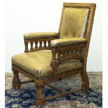 Victorian Gothic oak open arm library chair, the turned fore legs with octagonal feet, brass sockets