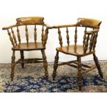Pair of beech Smokers Bow type arm chairs, stepped curved backs and saddle moulded seats on turned