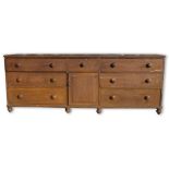 Large Victorian painted and grained pine dresser, with moulded top above seven drawers and cupboard,