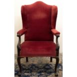 George III style wingback open armchair, with arched cresting and open arms with leaf scroll