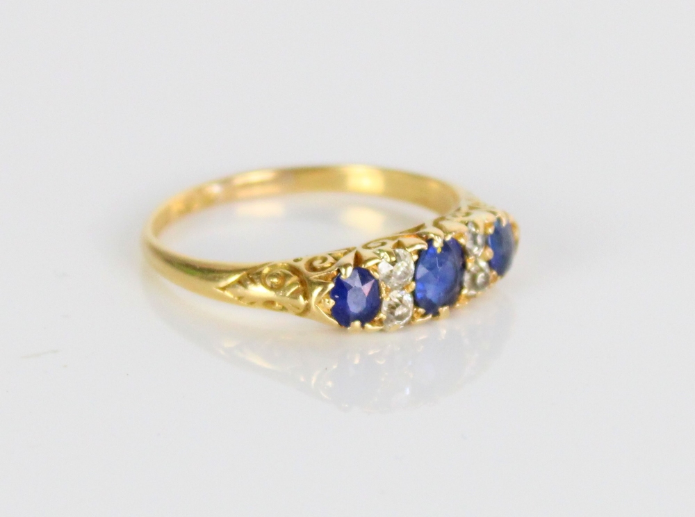 18ct yellow gold sapphire and diamond ring, the three graduated round cut sapphires separated by - Image 3 of 3