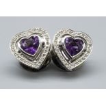 Pair of 18ct white gold amethyst and diamond heart shaped stud earrings by Theo Fennell, stamped