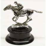After Louis Lejeune: a chromed metal car mascot in the form of a racehorse with jockey up, stamped