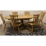 Stewart Linford Furniture - an oak dining table, oval extending top on baluster turned column and