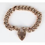 Early C20th yellow metal bracelet, the curb links connected by 9ct gold marked heart shaped