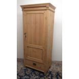 C20th stripped pine wardrobe, with moulded cornice and panel door above a drawer, W81cm D56cm H187cm