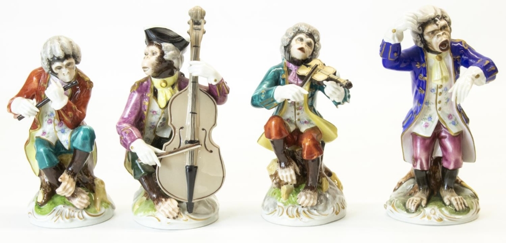 Set of four continental porcelain Meissen style monkey bandsmen, decorated in colours, on circular