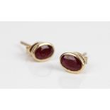 9ct yellow gold stud earrings set with oval cut rubies, stamped 375, 1.1g
