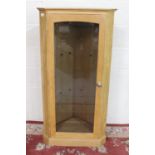 Light oak corner cabinet, glazed door with two shelves on plinth base, W65cm D40cm H129cm