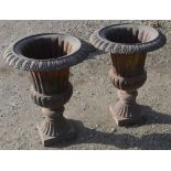 Pair of Regency style cast iron urns on square tapering pedestals H71 x W54cm (2)