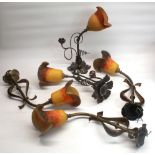Set of five Art Nouveau style wall lights with wrought iron scroll decoration and amber tinted