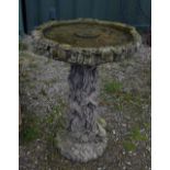 Large bird bath with rustic design of leaves and bark and two baby rabbits, H72cm