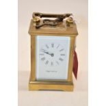 Mappin & Webb Ltd. C20th brass carriage time piece with signed white enamel dial, Roman numerals and