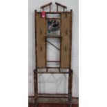 Edwardian bamboo hall stand, raised back with bevelled mirror, six hooks and rattan panels, W71cm