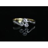 18ct gold three stone diamond ring, the three brilliant cut diamonds claw set on scrolled platinum