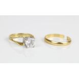 18ct yellow gold ring set with clear stone in white metal mount and an 18ct yellow gold band,