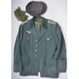 Two wartime German uniform jackets, a shirt, 2 caps and a leather belt (no sizes present).