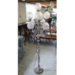 Silvered metal floor lamp, nine branches with shades on baluster column and stepped square base,