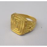 Yellow metal rectangular faced ring with engraved detail, stamped 916, size U1/2, 10.6g