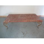 Contemporary coffee table, moulded edge rouge marble top on wrought metal base with four S scroll