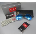 Pair of Ray-Ban Aviator sunglasses with blue mirror lenses, in black case with unopened wipe,