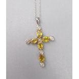 10ct white gold crucifix pendant set with oval cut yellow sapphires and round cut diamonds, on