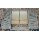 Distressed metal framed mirror, enclosed by a pair of louvre doors, W107cm H72cm