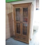Contemporary oak side cabinet, with two glazed doors above a drawer on bracket feet, W89cm D36cm