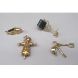 Three 9ct yellow gold charms, including a scarecrow, a clog, helmet and tool, all stamped 375, gross