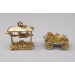 Two 9ct yellow gold charms including a pig on spit over a fire and a vintage car, both stamped