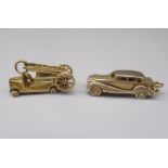 Two 9ct yellow gold charms including a fire engine and a saloon car opening to reveal interior, both