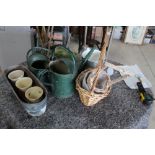 Collection of watering cans of various styles, wicker baskets, planters, etc.