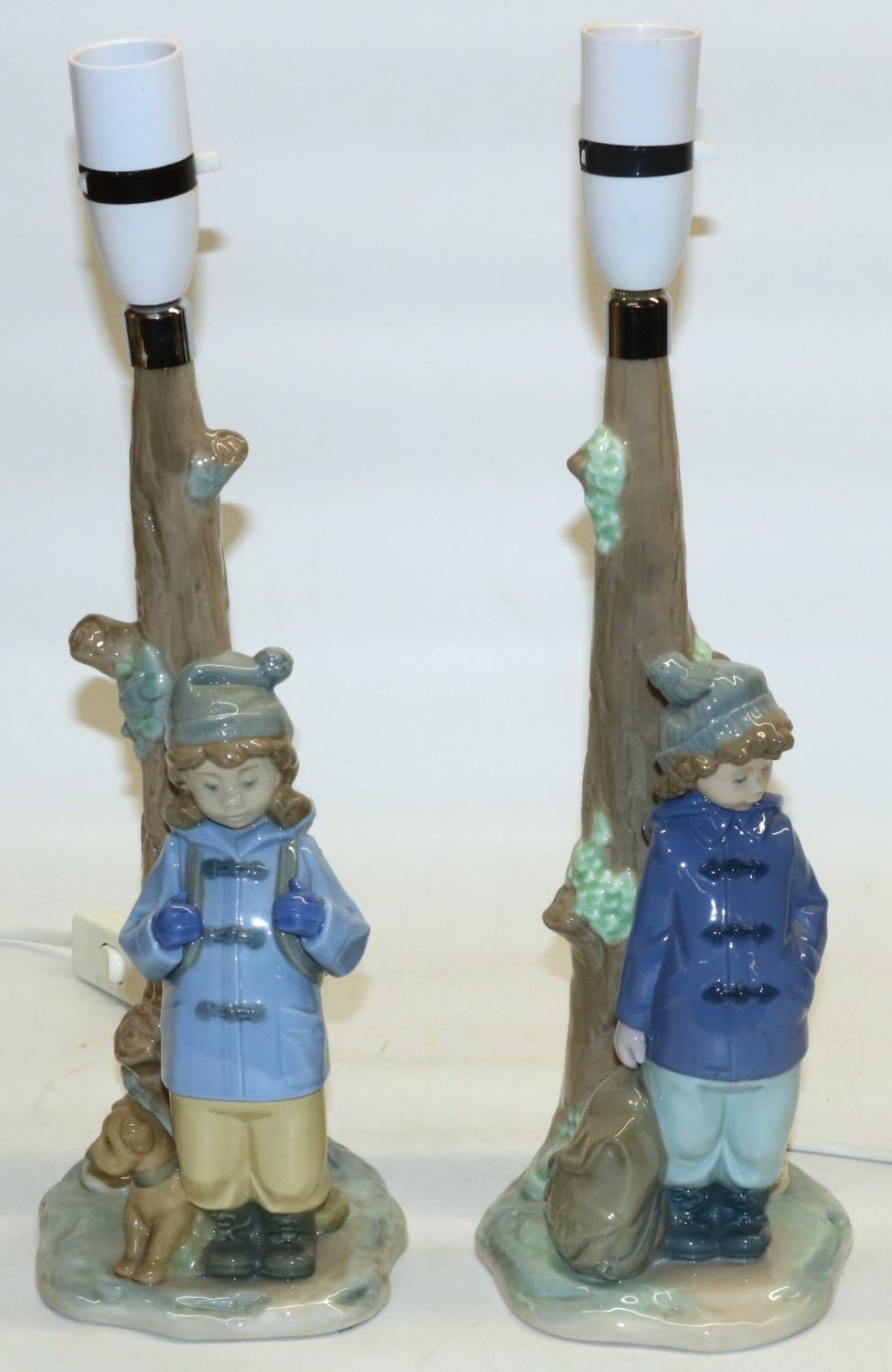 Two Nao table lamp bases modelled as children under trees, H38.5cm (2)