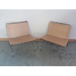 Pair of tubular chromed metal framed low chairs with slung leather seats and backs, W67cm D66cm