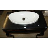 White ceramic oval wash basin, on black single drawer unit with Artelinear top and cabriole leg,