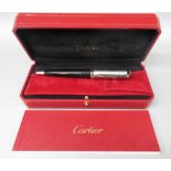 Cartier silver and black ballpoint pen, cased with instructions and certificate, boxed