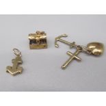 Three 9ct yellow gold charms including pirates chest opening to reveal treasure, anchor and